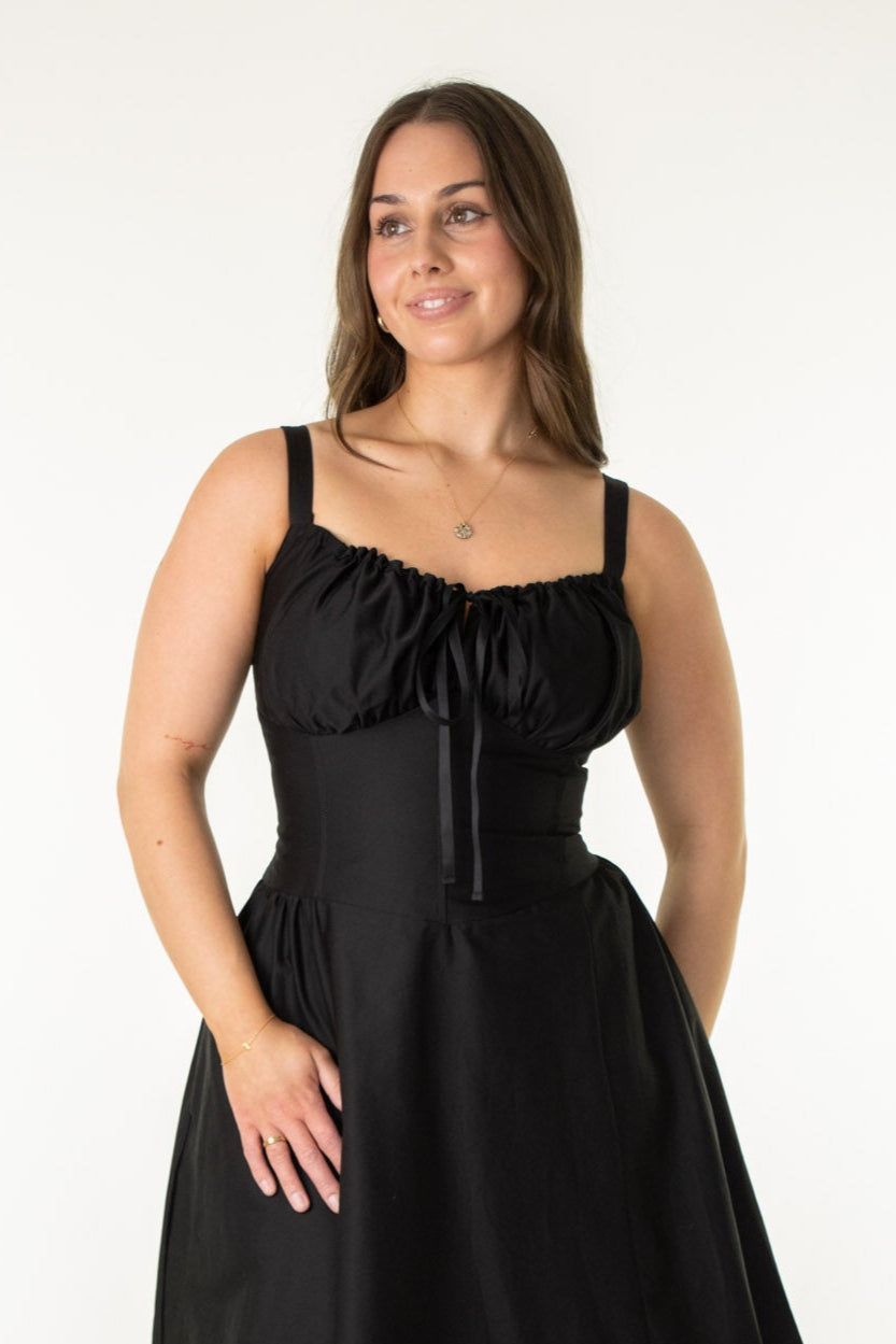 Woman wearing a black dress on a white background